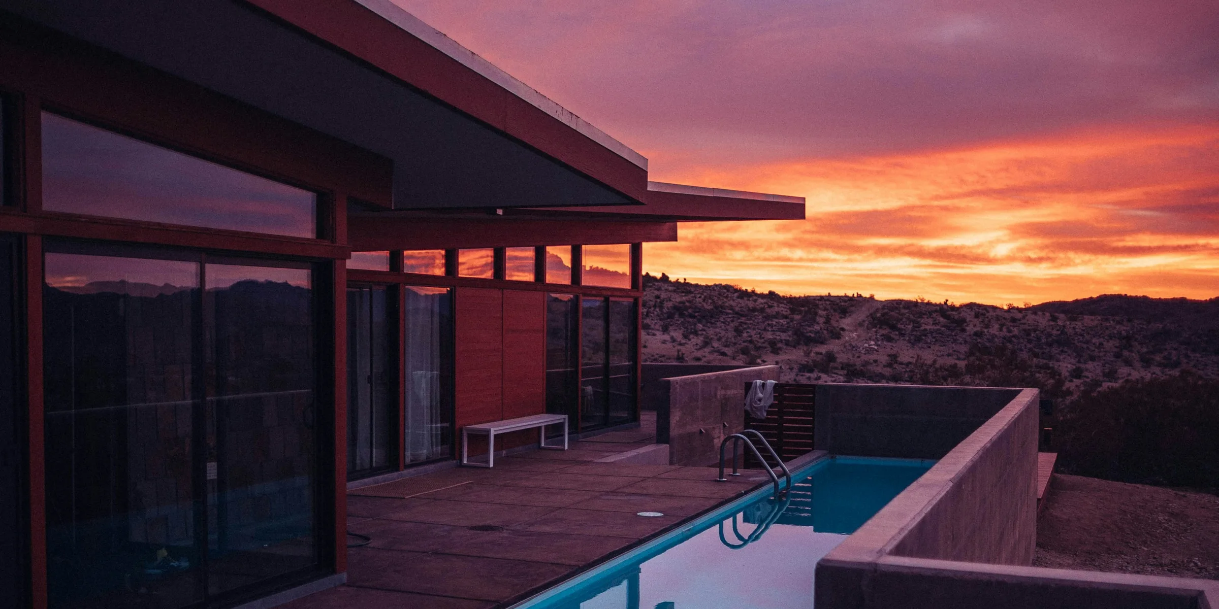 A South Florida house silhouetted against an orange sunset