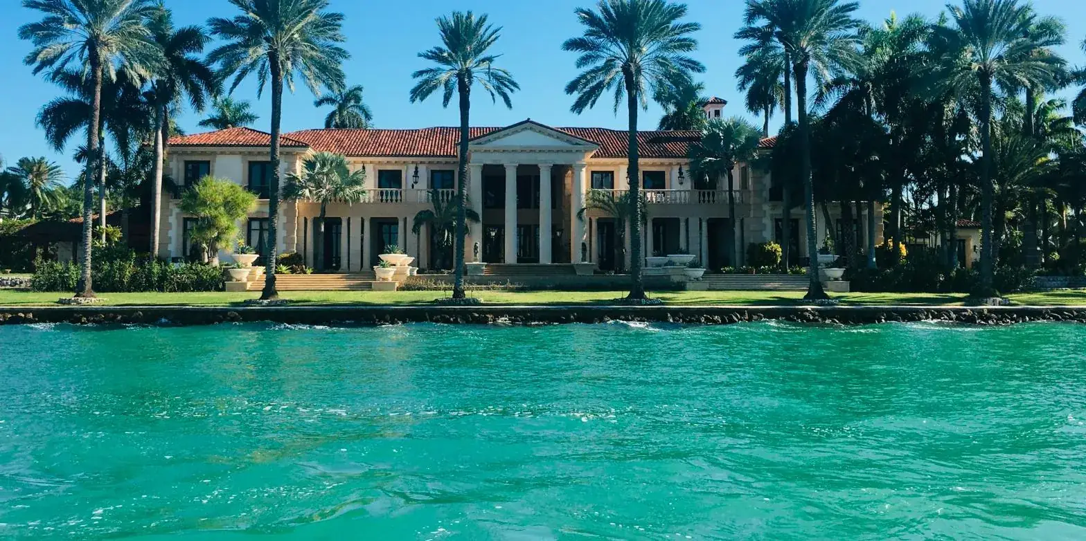 A waterfront Florida estate lined with royal palms